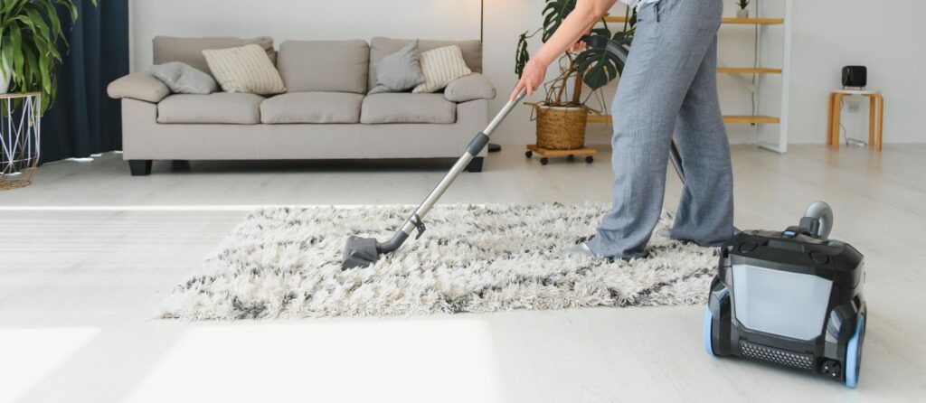 Woman with accumulator vacuum cleaner urban fresh